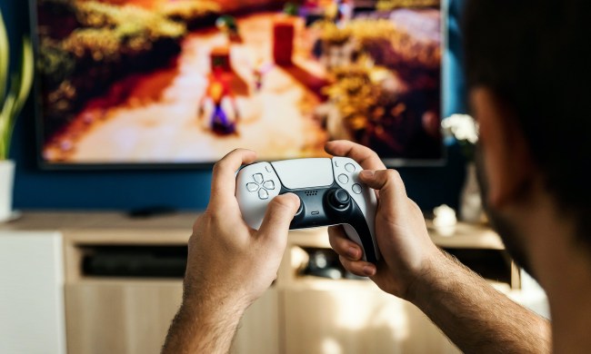 A person plays Crash Bandicoot using a PS5 DualSense controller.
